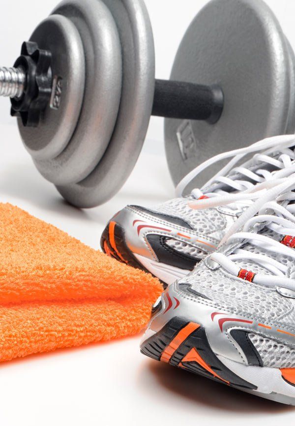 gym shoes and towel next to dumbbell