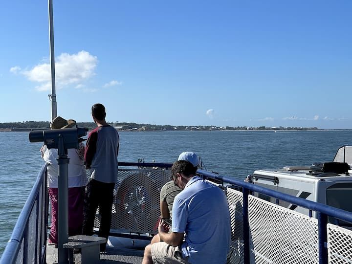 A group of people on a boat looking at the water