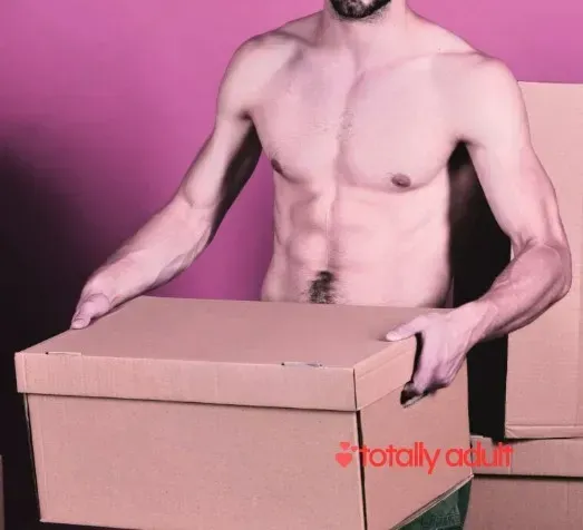 A man carrying a large box of adult products, emphasizing the benefits of buying from an online sex shop in New Zealand, where you can shop in the comfort of your home with fast delivery instead of heading to a physical store.