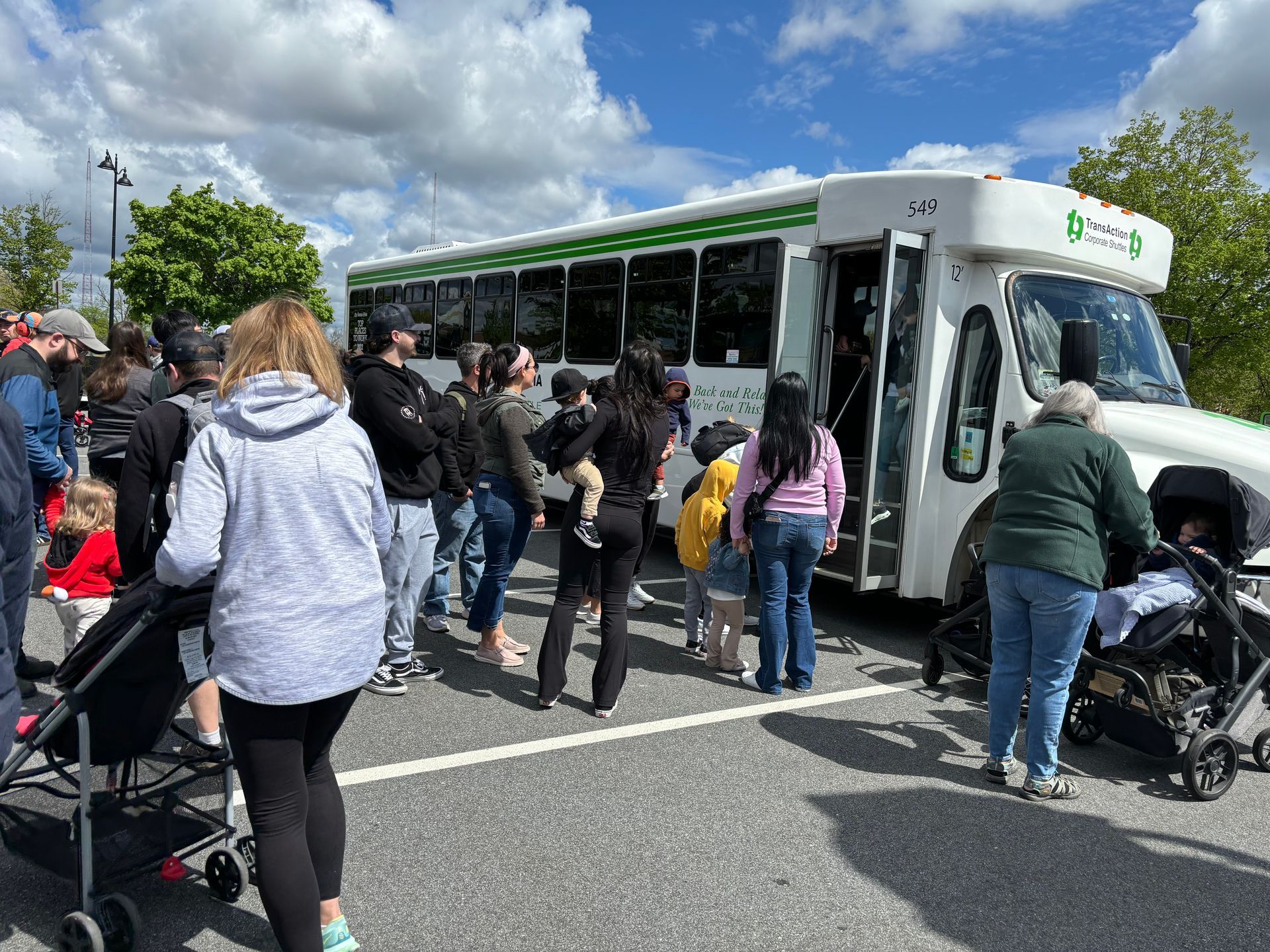 group of people boarding shuttle bus