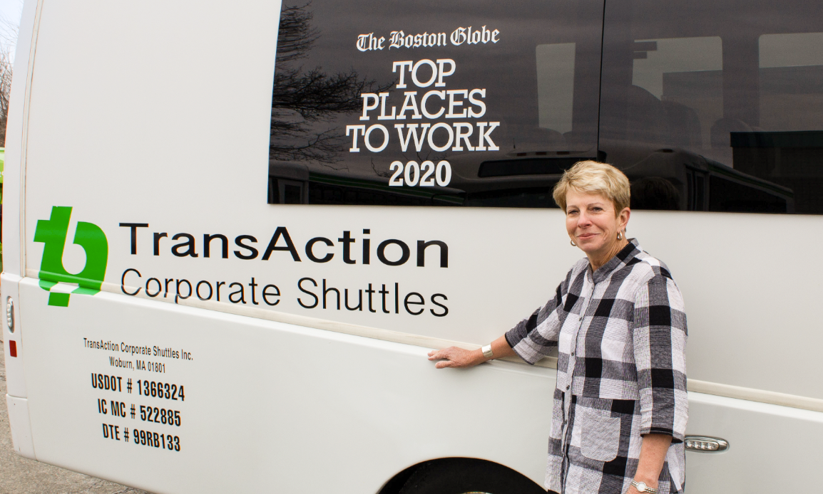 Founder Cindy Frene stands next to a TransAction Corporate Shuttle