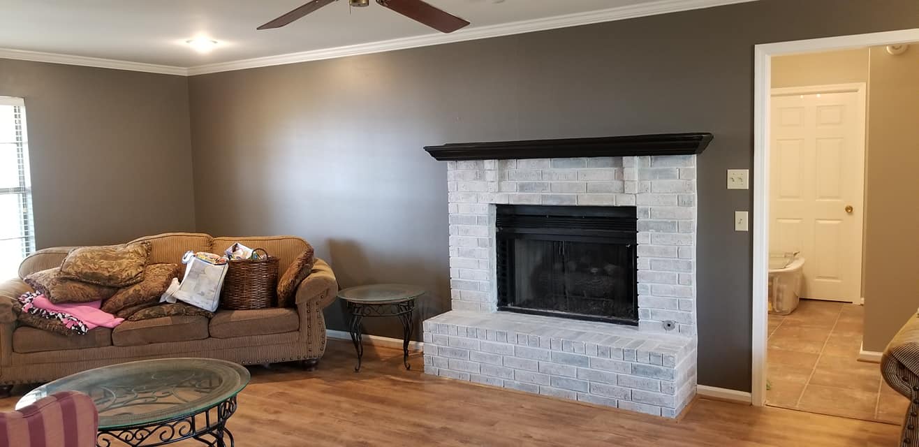 A living room with a fireplace and a couch.