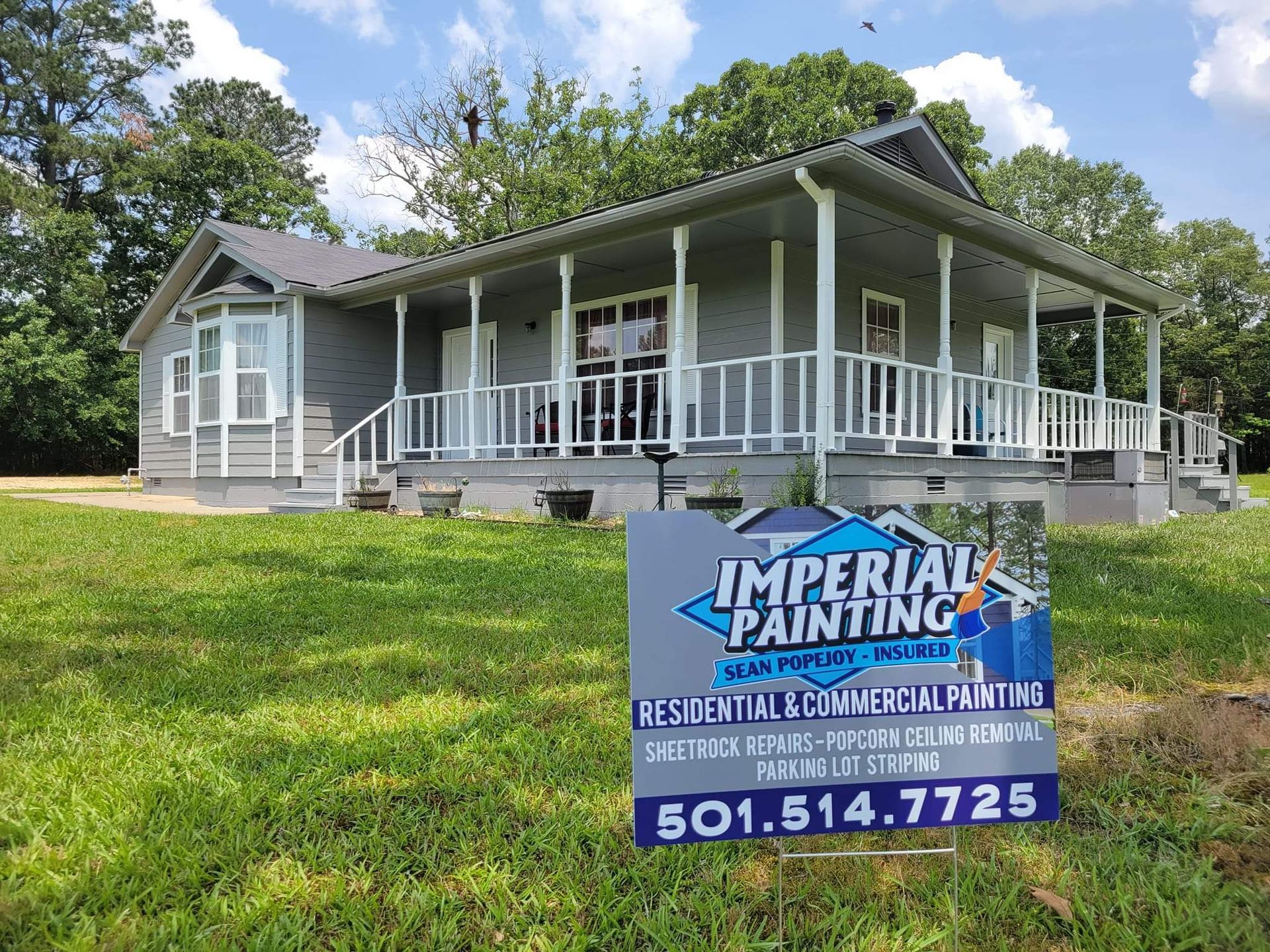 A house with a sign in front of it that says imperial painting.