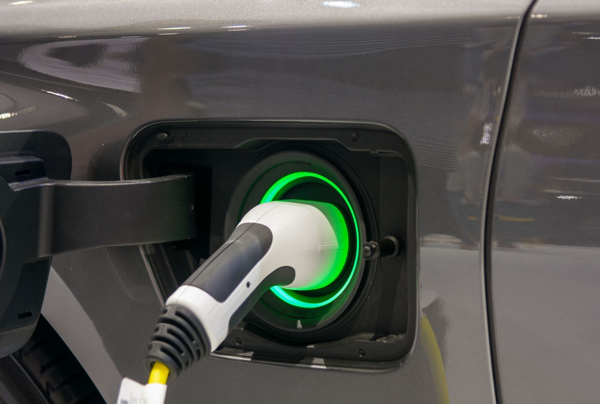 A close up of an electric car being charged.