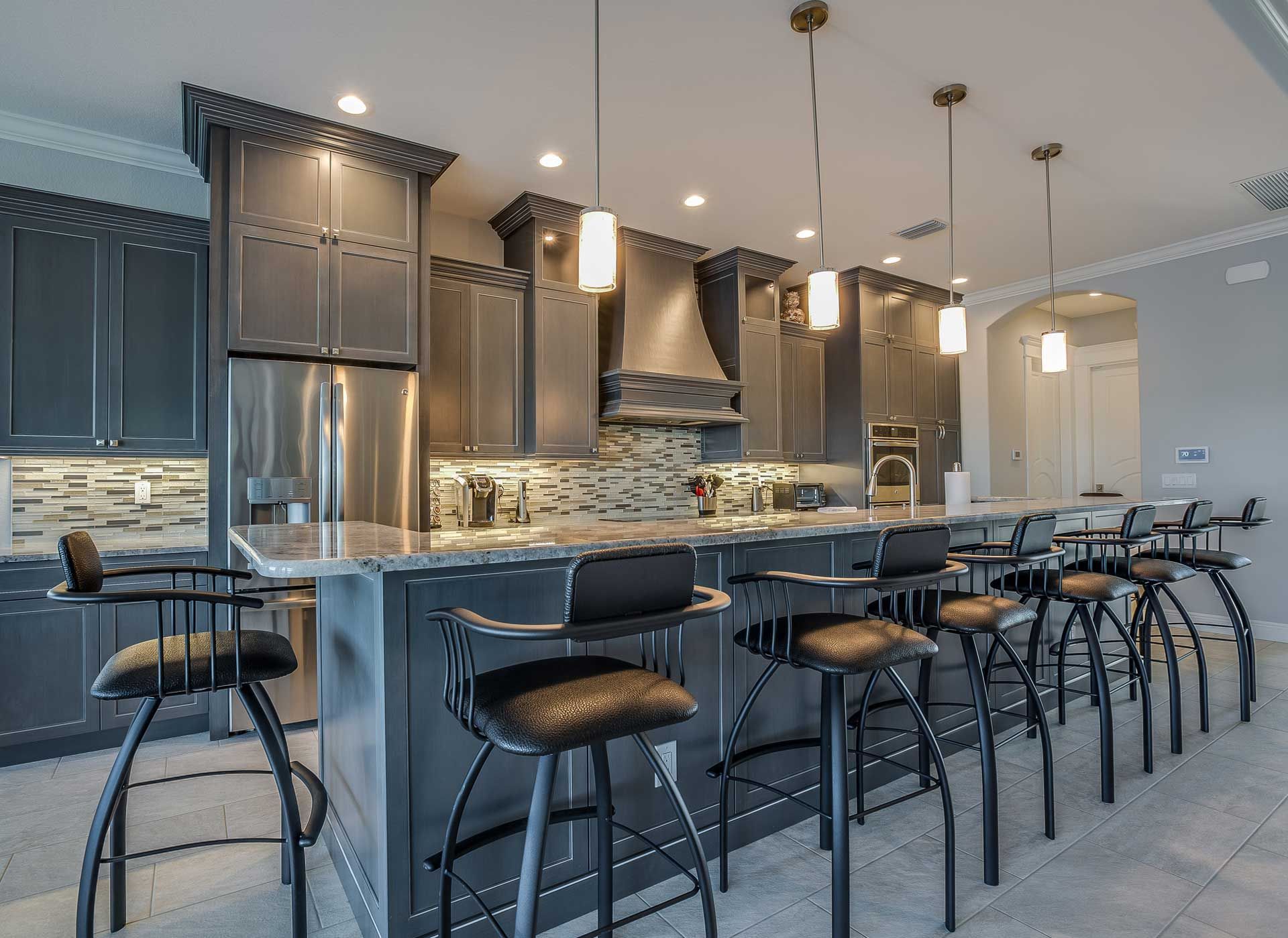 A kitchen with gray cabinets and stainless steel appliances