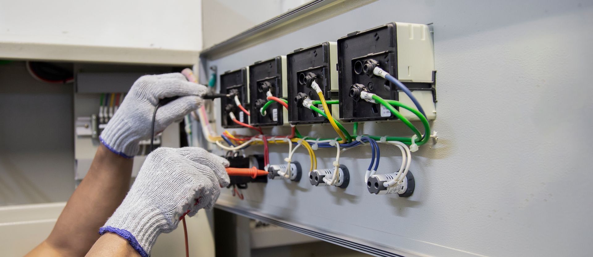 A man in a blue uniform is working on a ceiling.