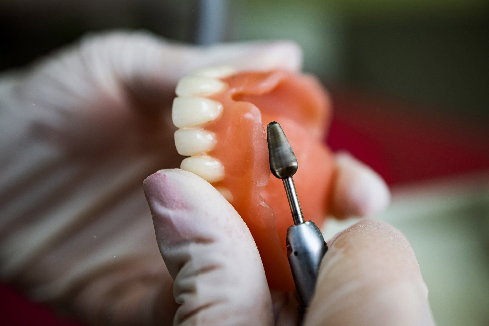 Technician shaping a prosthesis tooth | Ringwood, VIC | Abstract Arch Denture Clinic