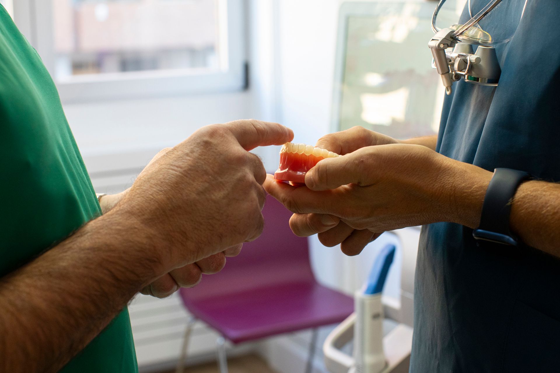A dental mock-up with dentures in dentist's hand.