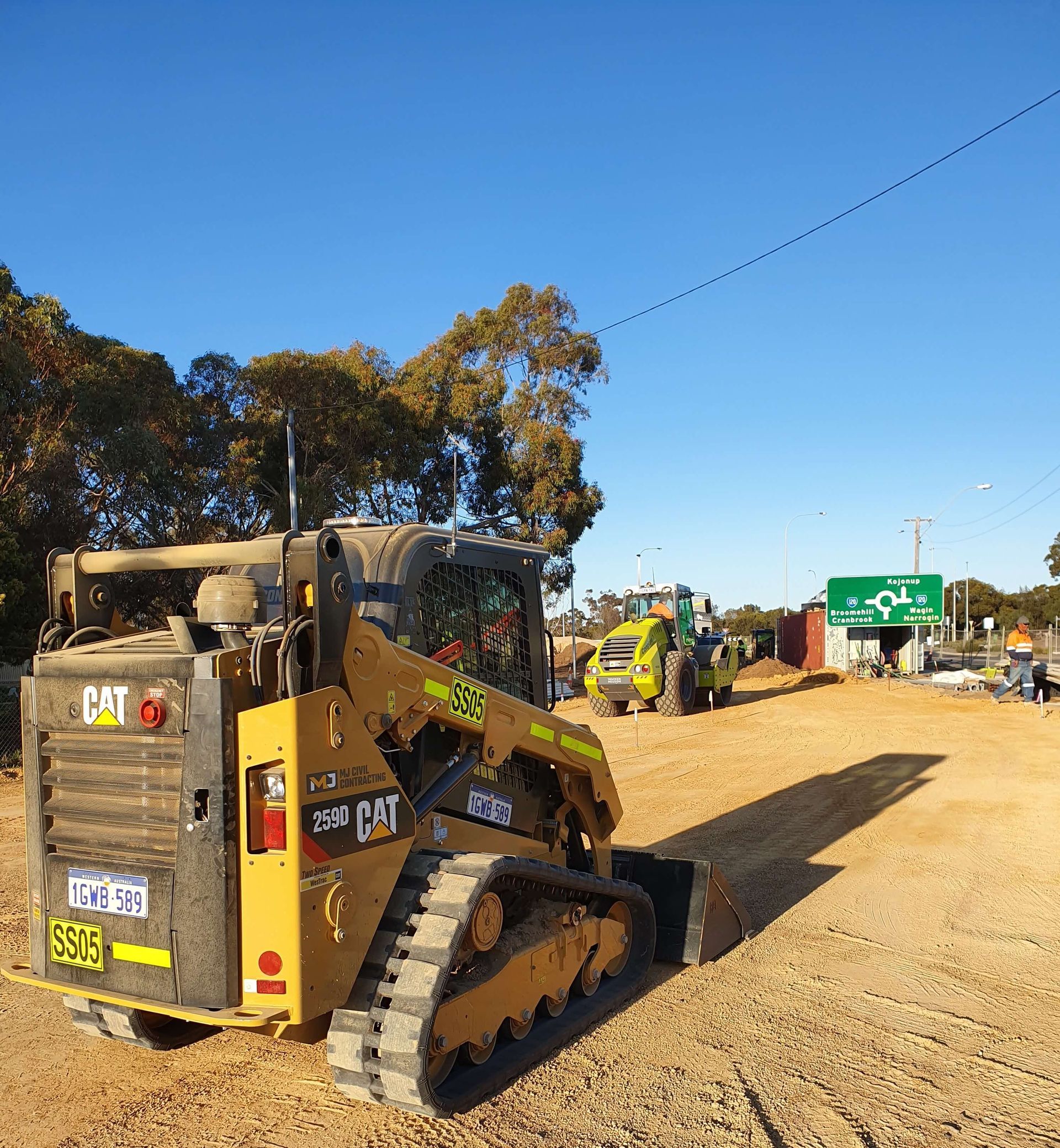 A cat bulldozer is parked in a dirt field
