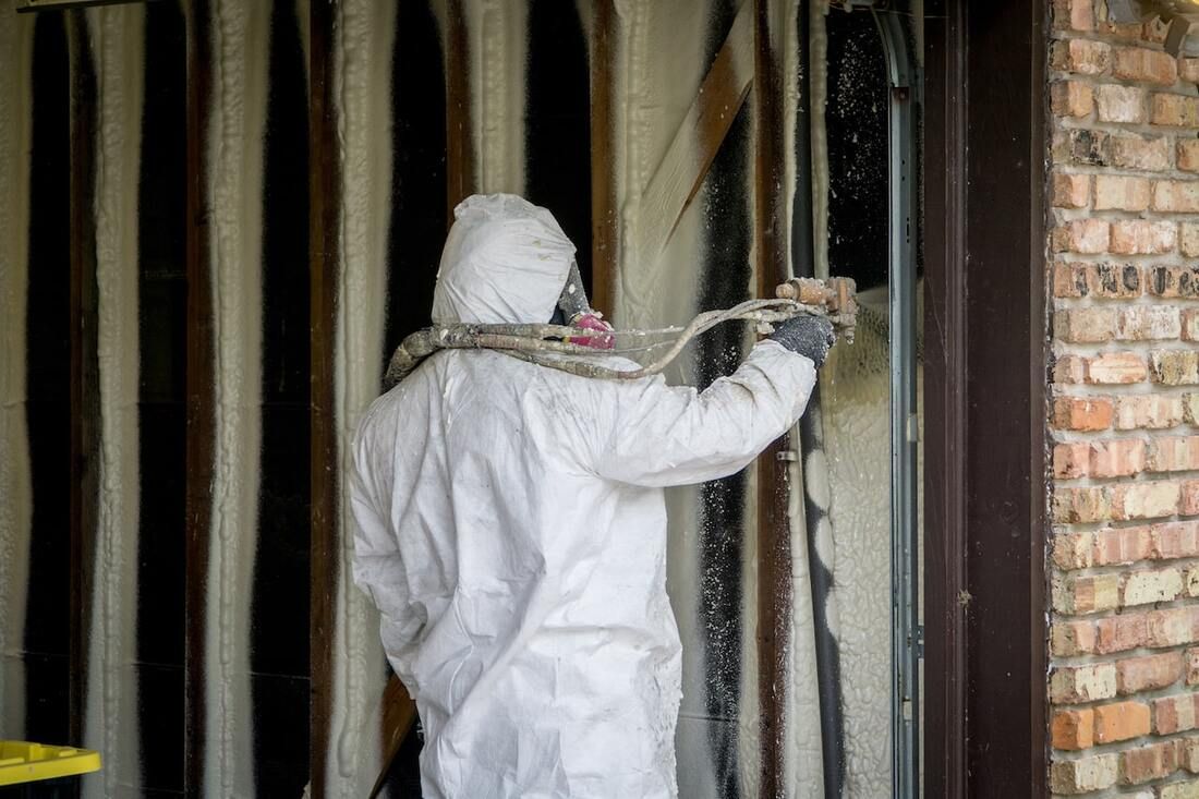 spray foam insulation expert performing spray foam insulation installation at a property in Joplin 