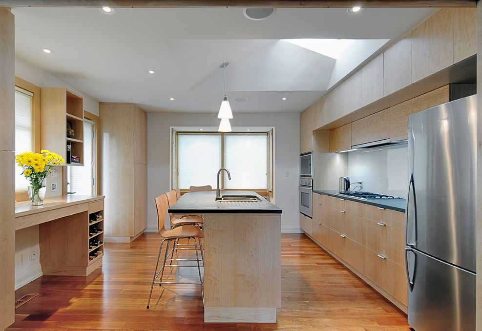 A kitchen with stainless steel appliances and wooden cabinets