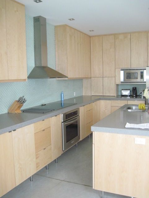 A kitchen with wooden cabinets and stainless steel appliances