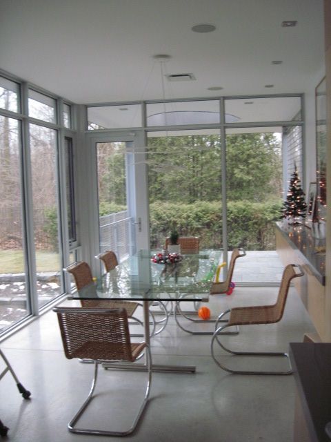A dining room with a glass table and chairs