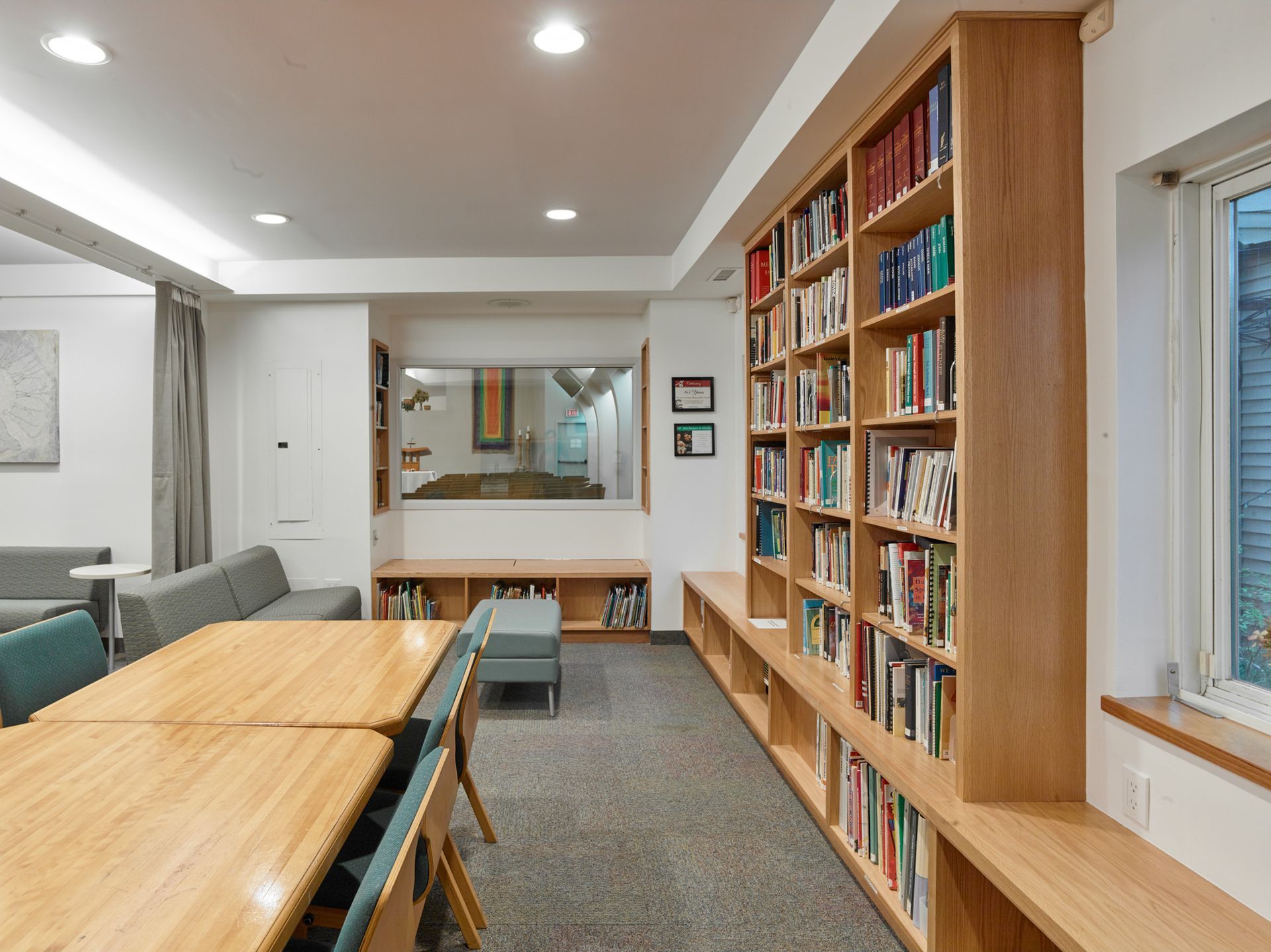 A room with a lot of bookshelves and tables