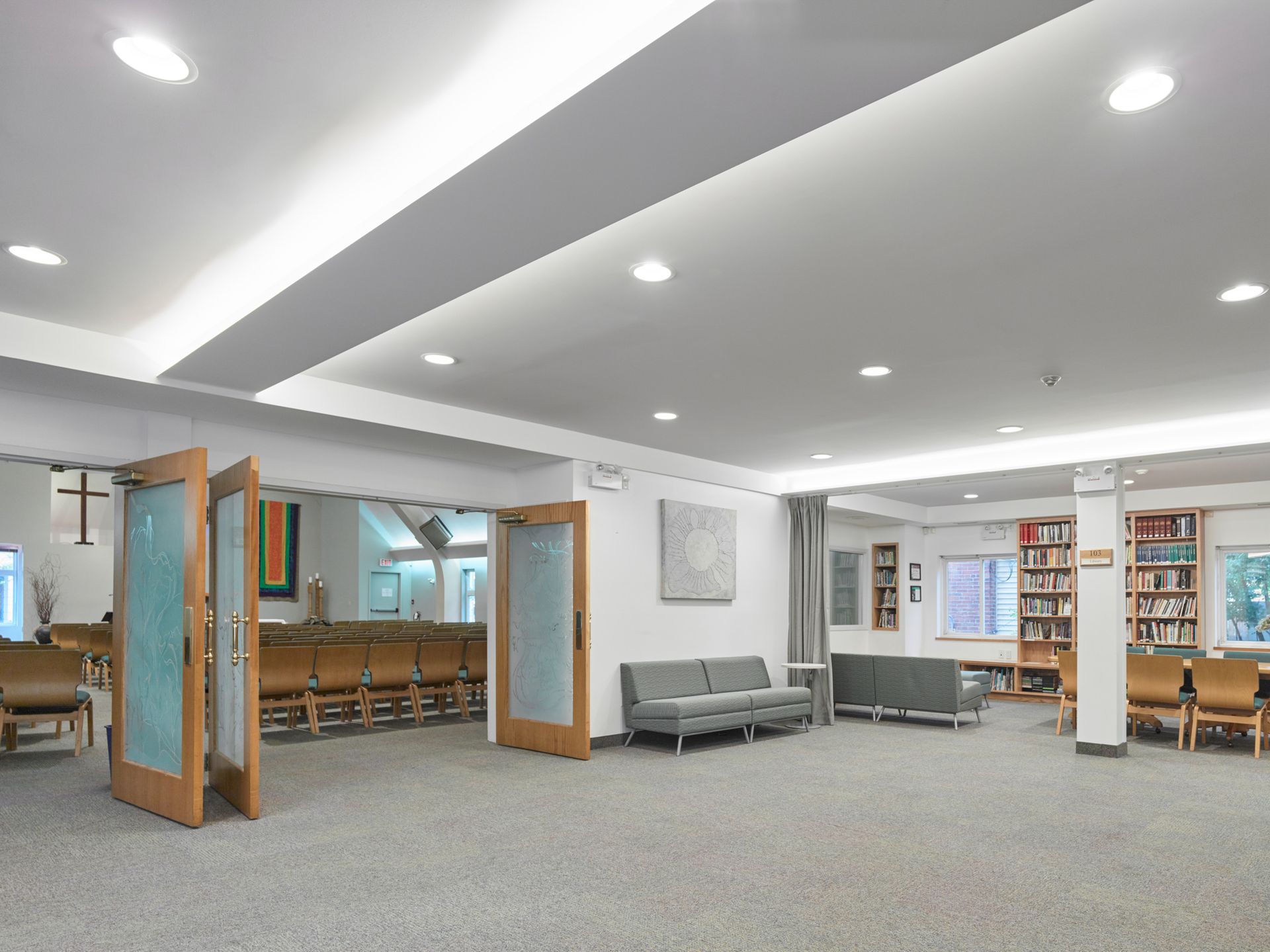 A large room with a couch and chairs in it