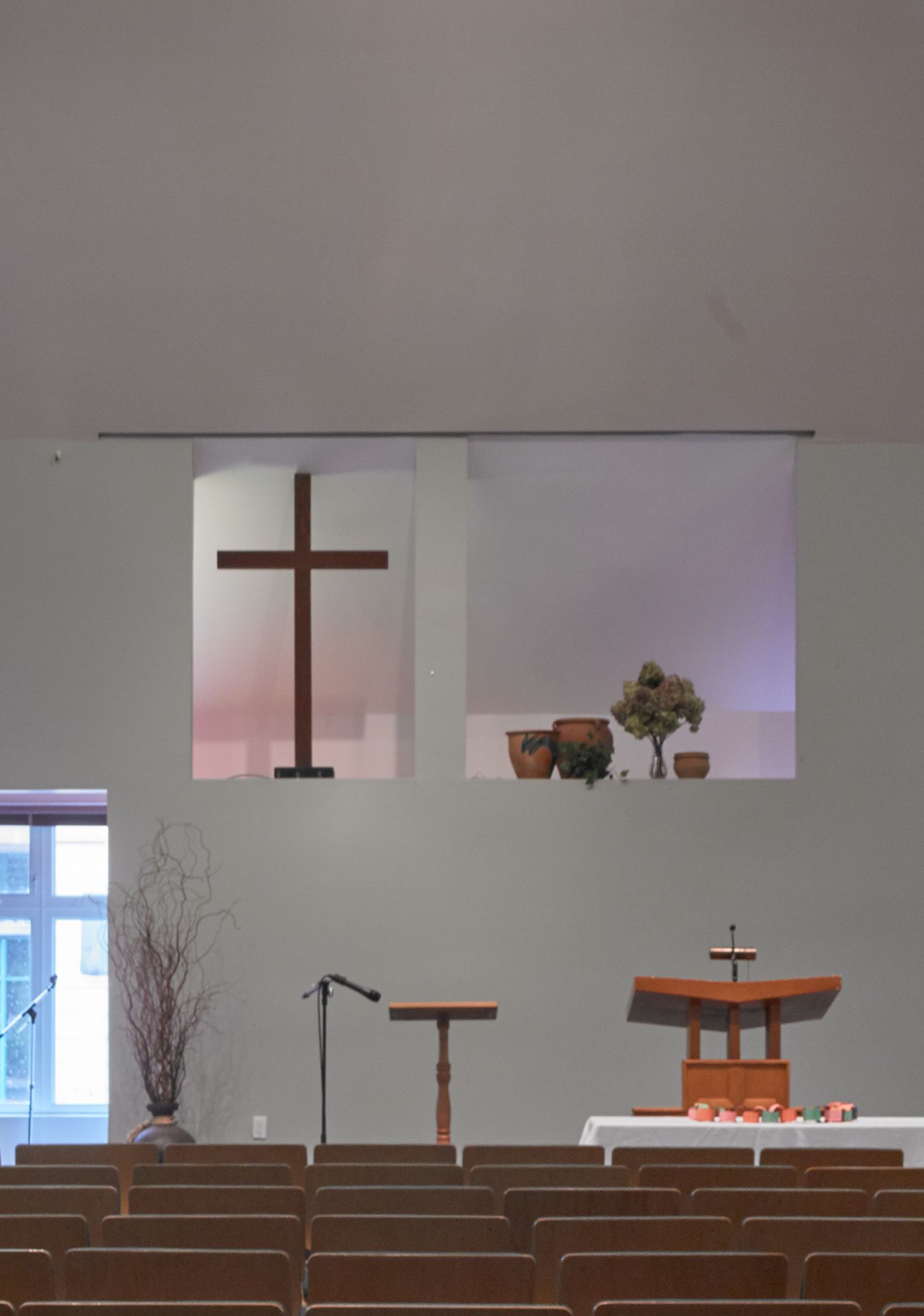 An empty church with a cross on the wall