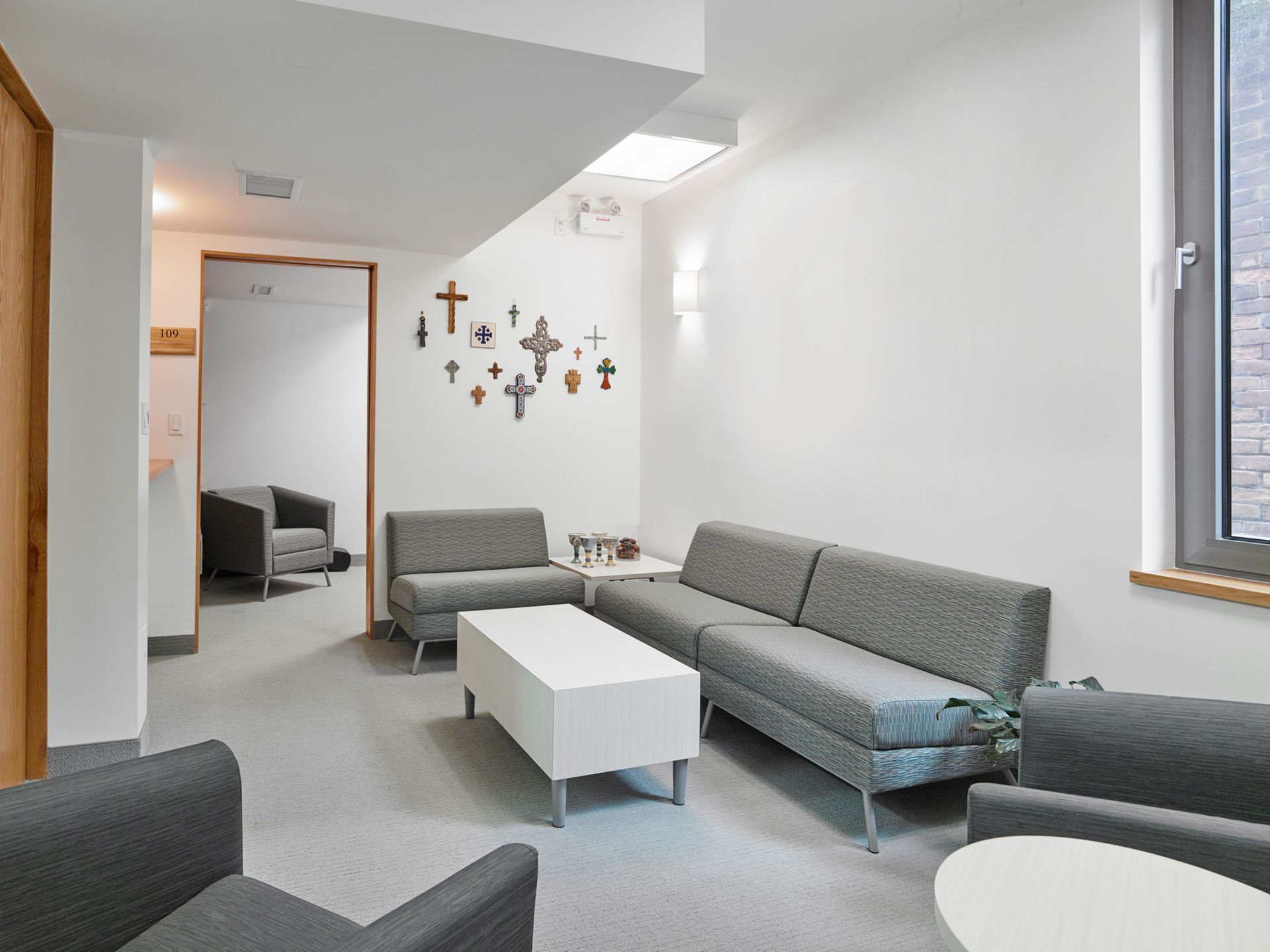 A living room with a couch , chairs , and a coffee table.