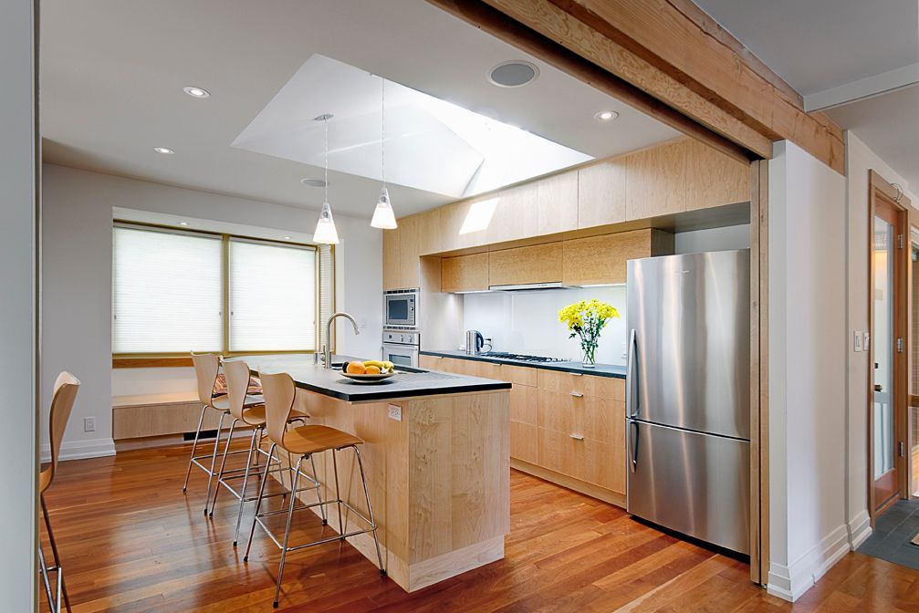 A kitchen with stainless steel appliances and wooden cabinets
