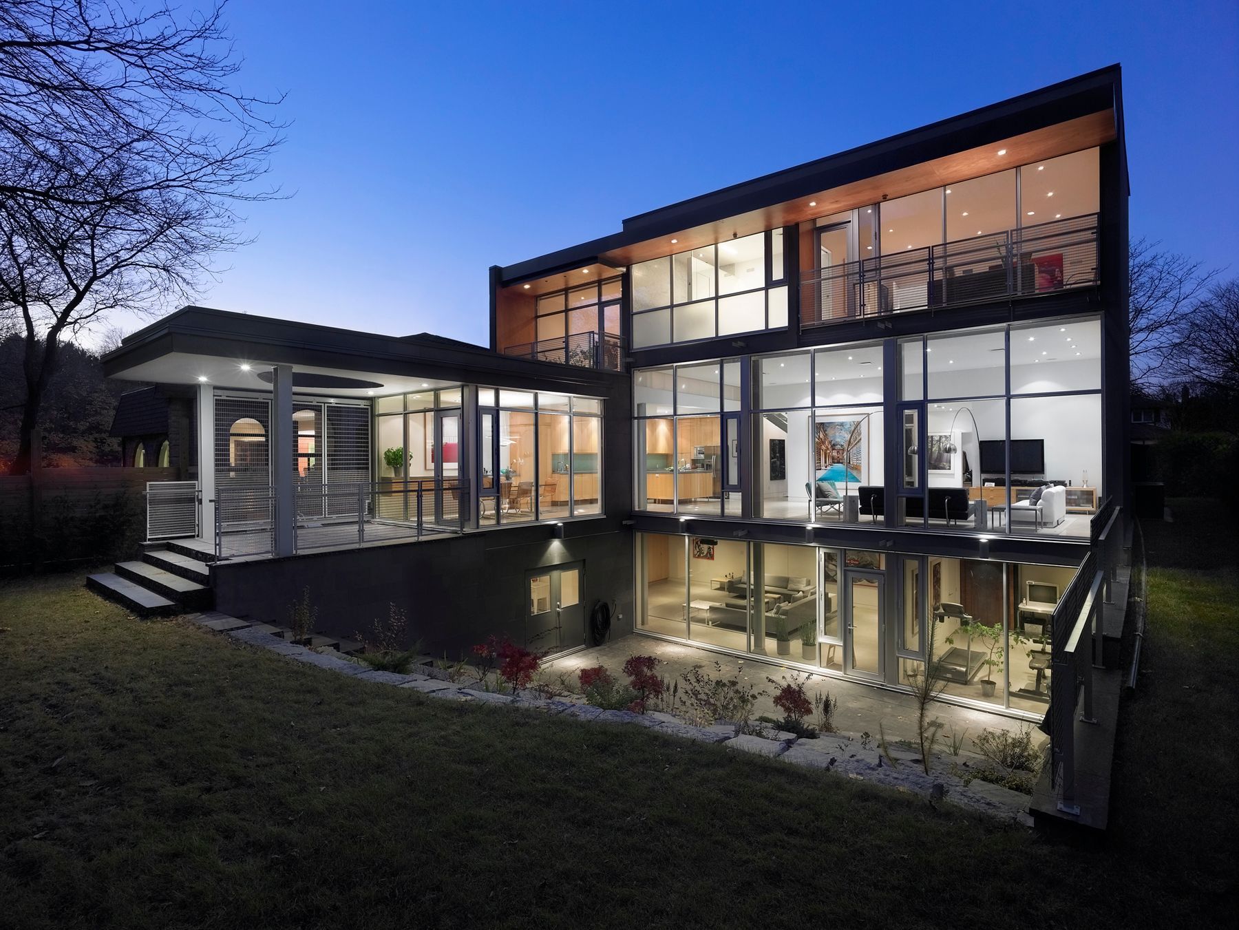 A large house with a lot of windows and a pond in front of it.