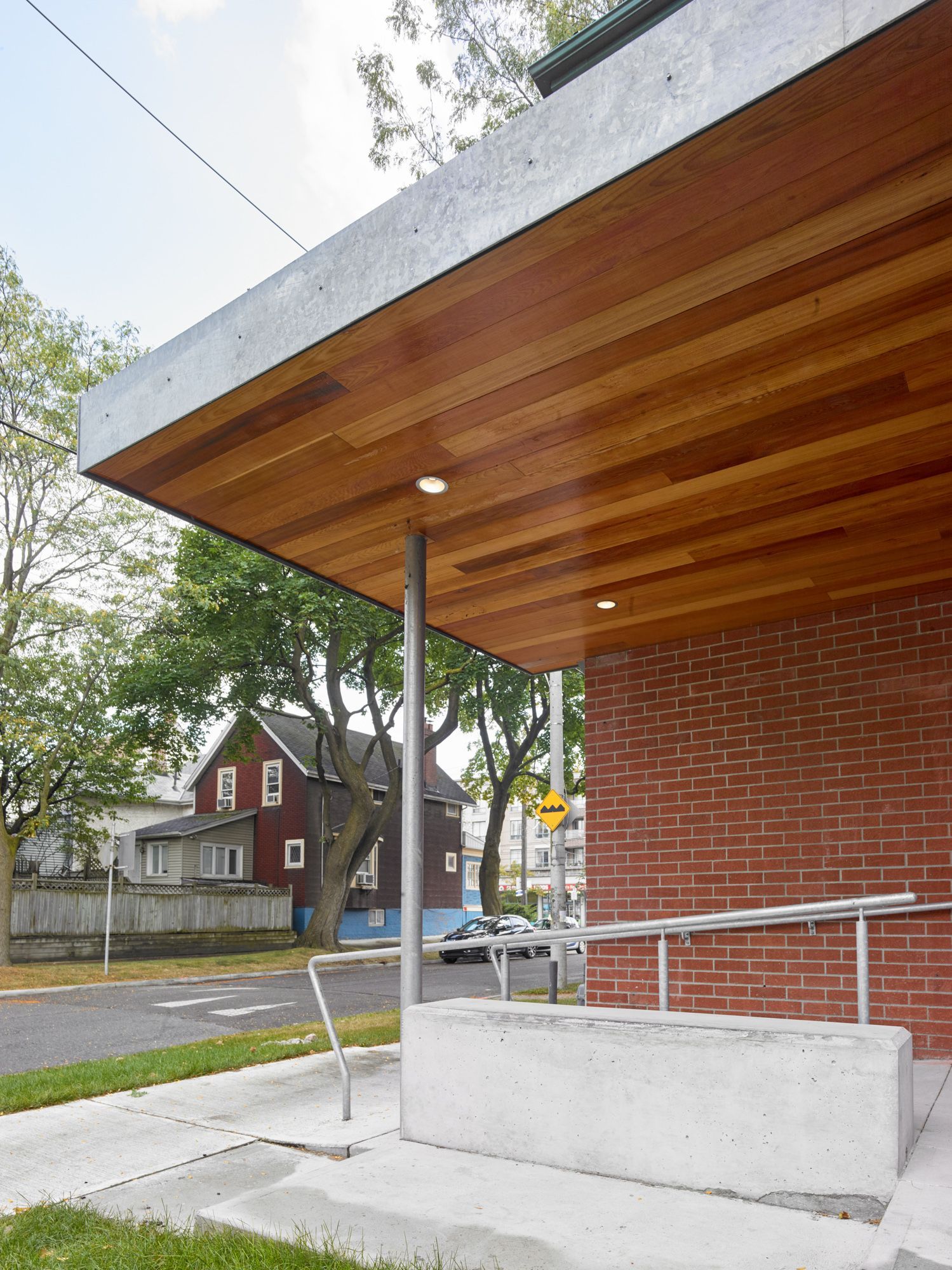 A brick building with a wooden roof and a ramp