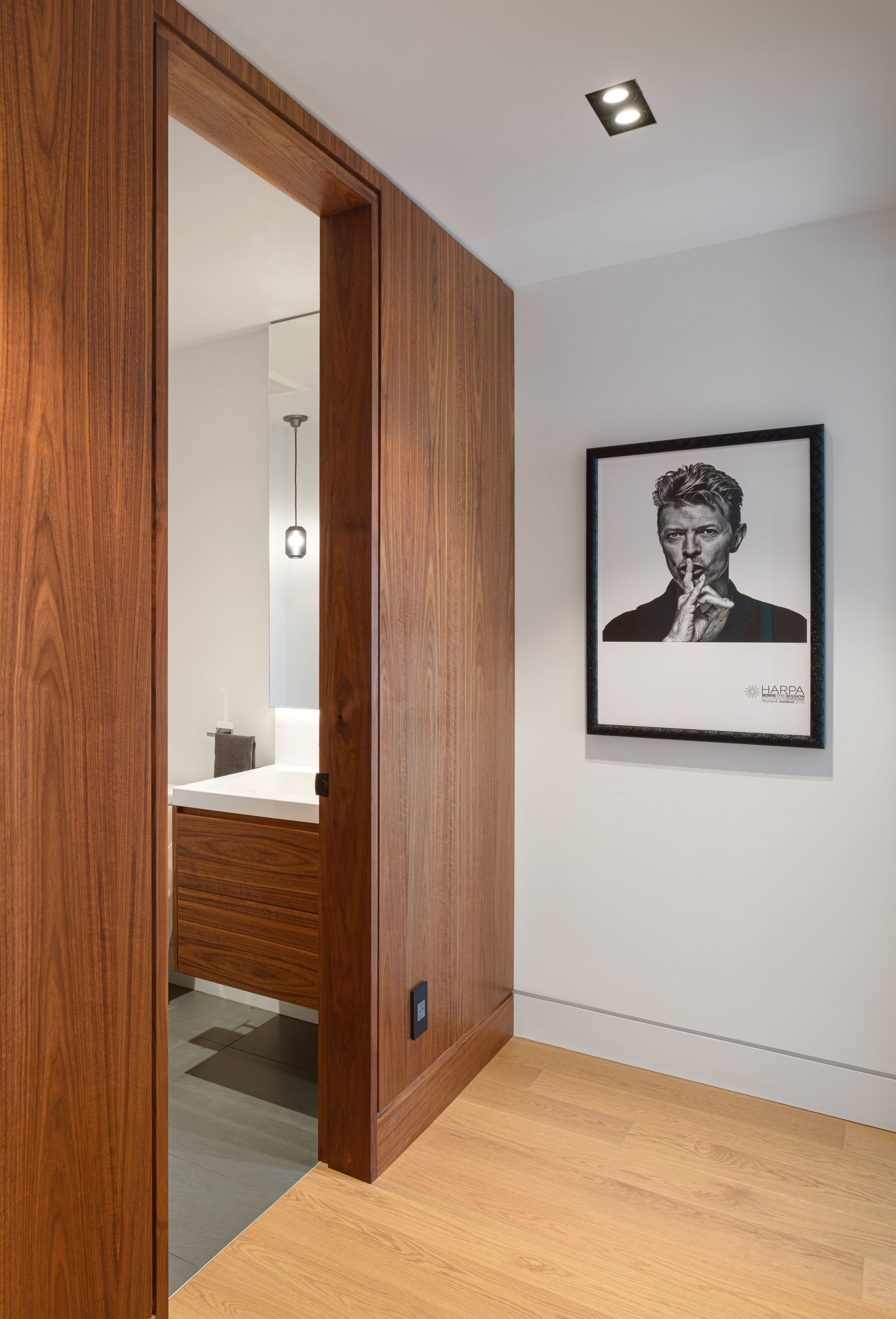 A hallway with a picture of a man on the wall.