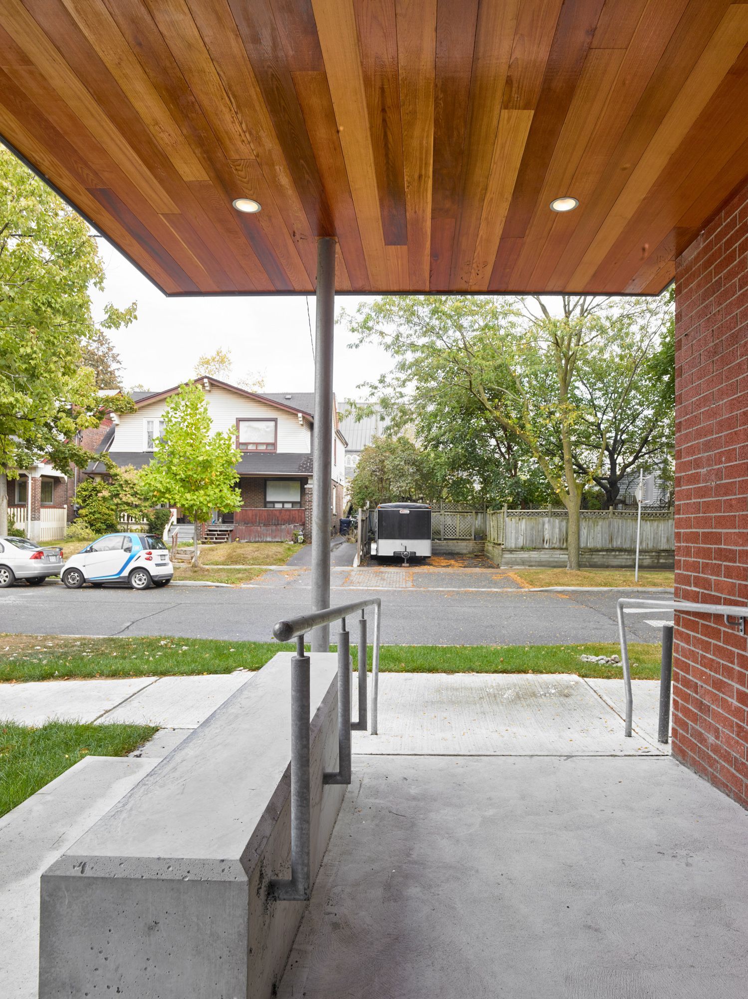 A brick building with a wooden ceiling and a bench