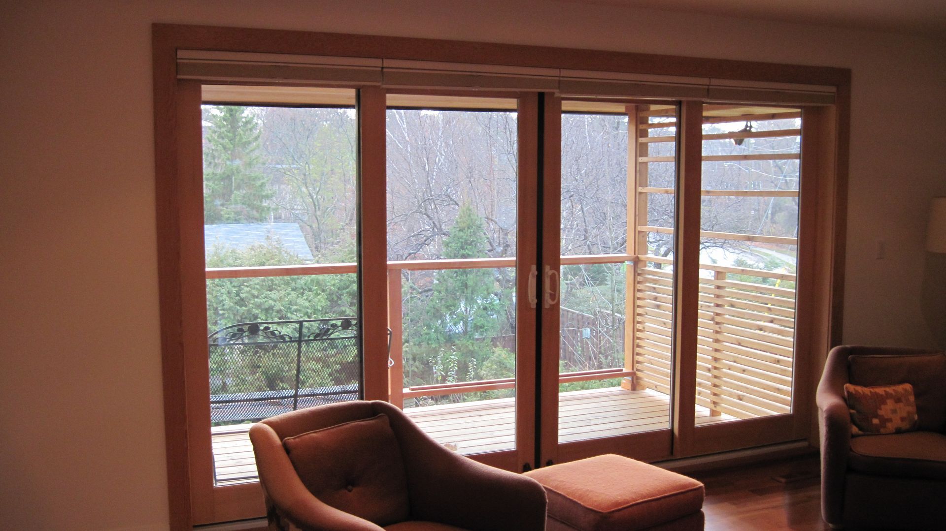 A living room with sliding glass doors leading to a balcony
