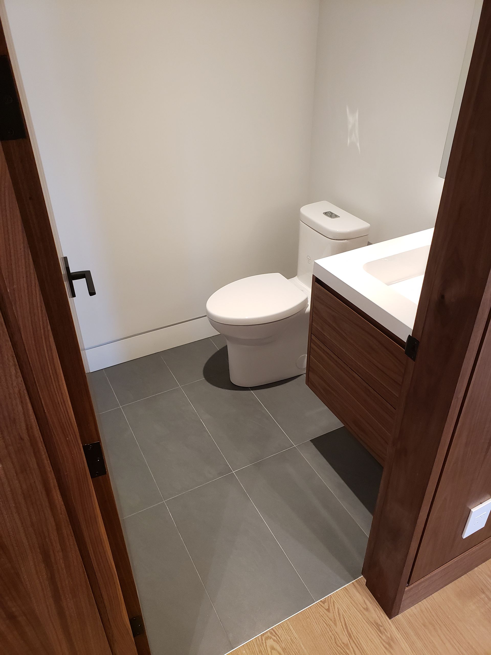 A bathroom with a toilet and a sink in it.