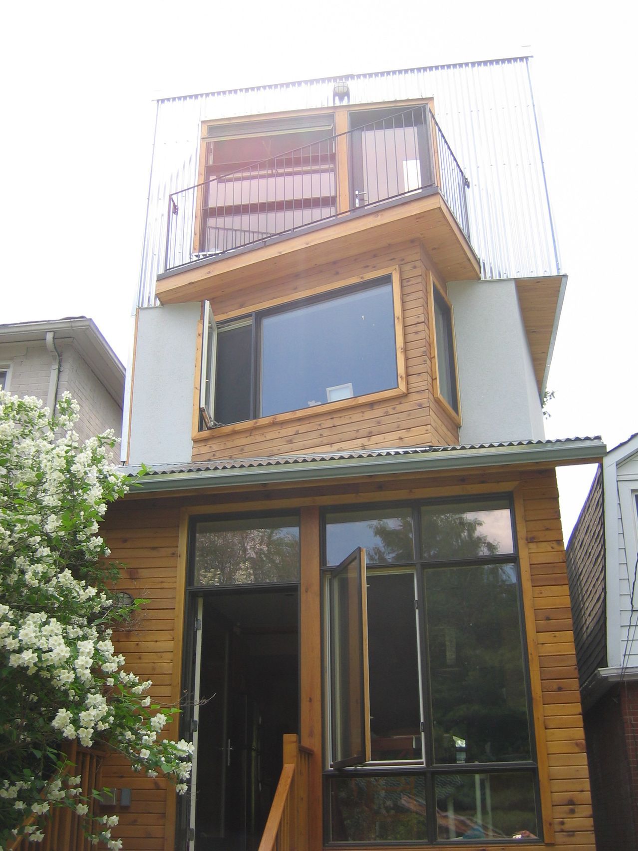 A house with a balcony on the top of it