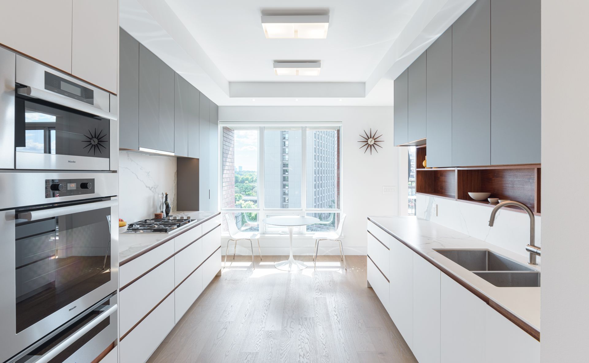 A kitchen with white cabinets and stainless steel appliances