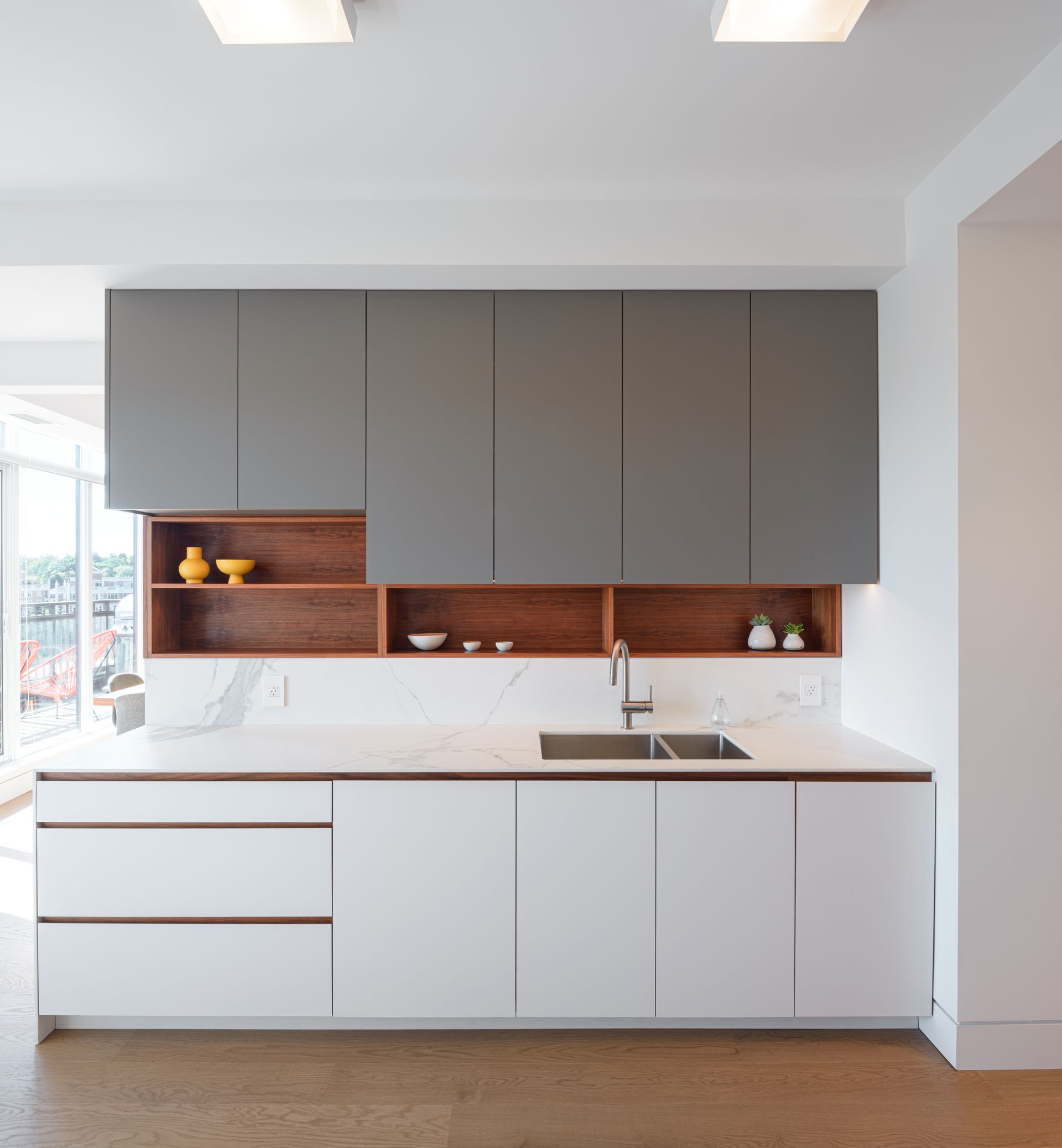 A kitchen with white cabinets and a sink