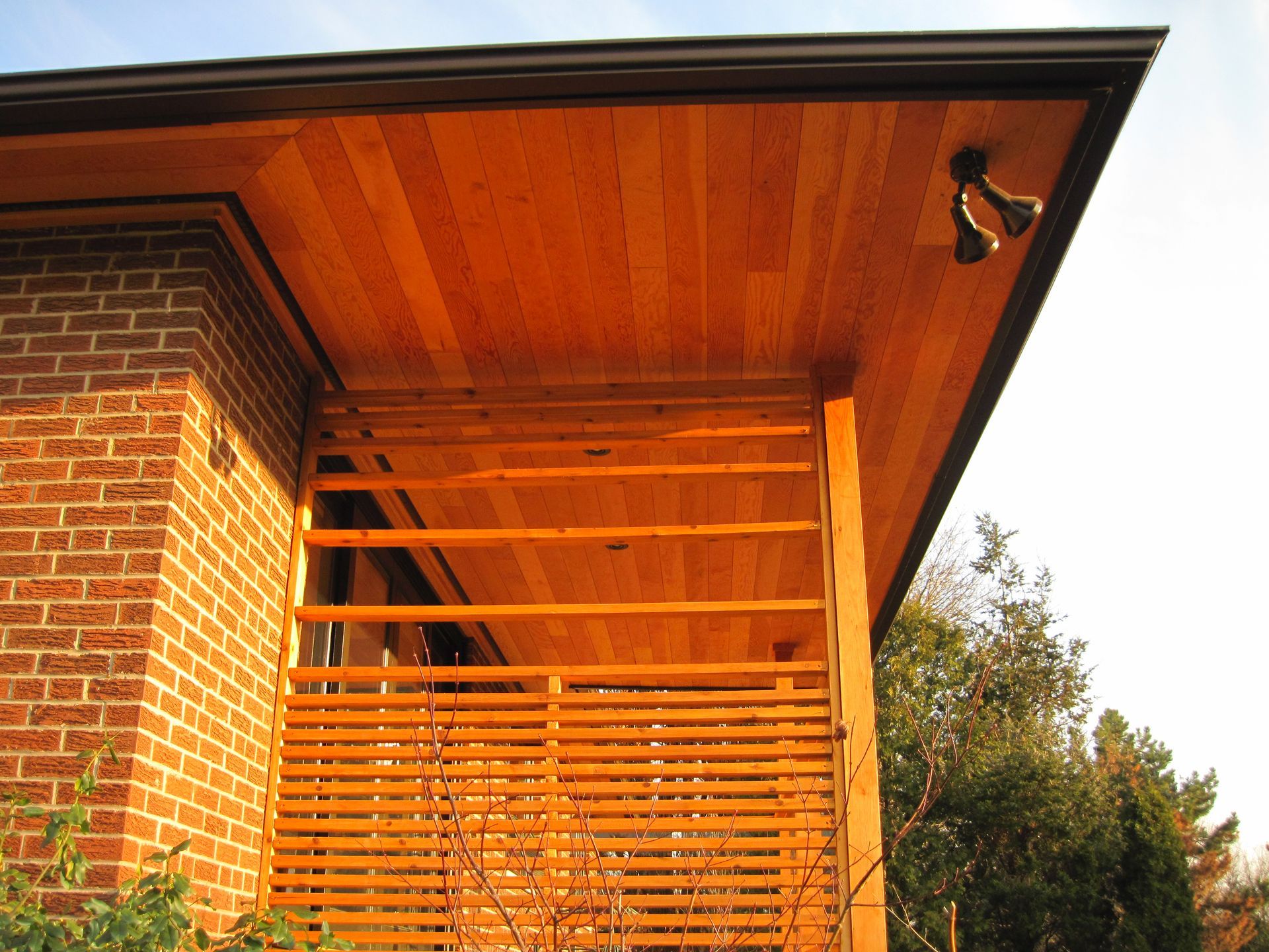A brick building with a wooden roof and a wooden railing