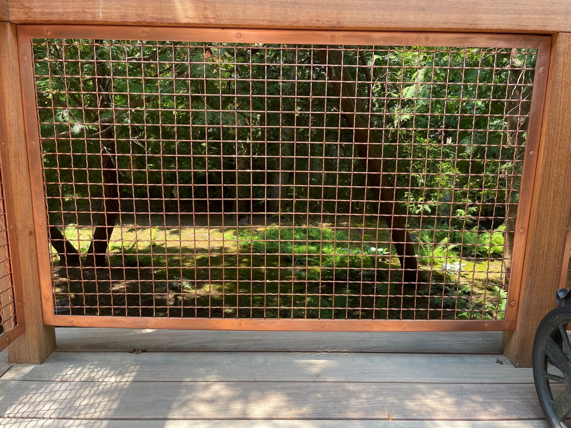 A wooden deck with a metal fence surrounding it