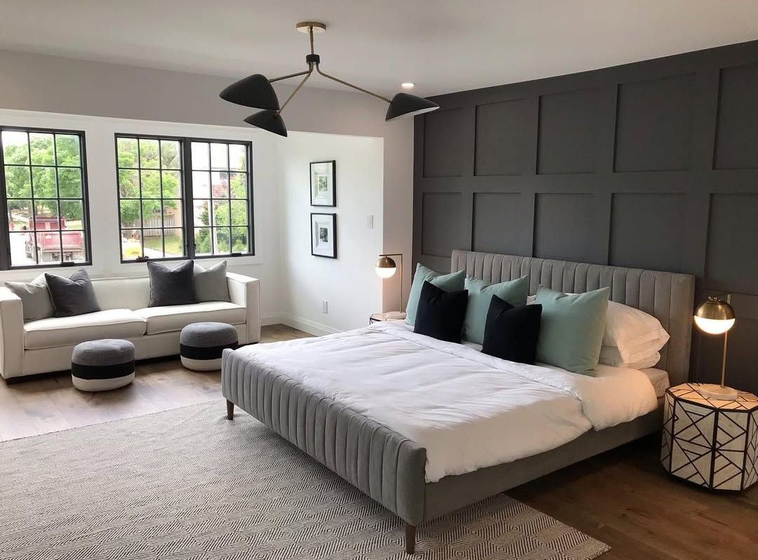 A bedroom with a large bed and a couch.