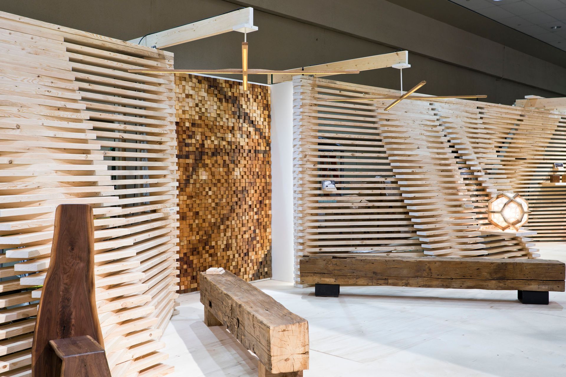 A wooden bench is sitting in front of a wooden wall.