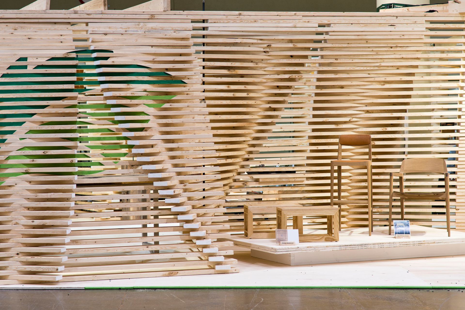 A model of a wooden room with chairs and tables