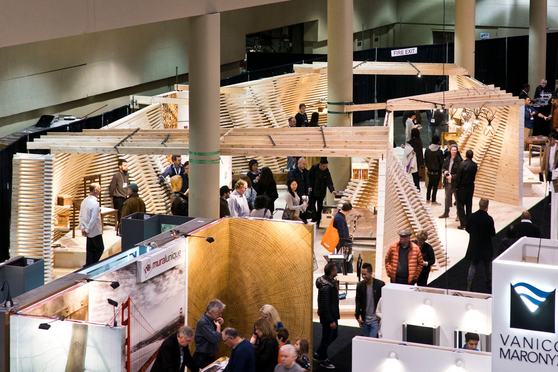 A group of people are gathered around a vanico marcy booth