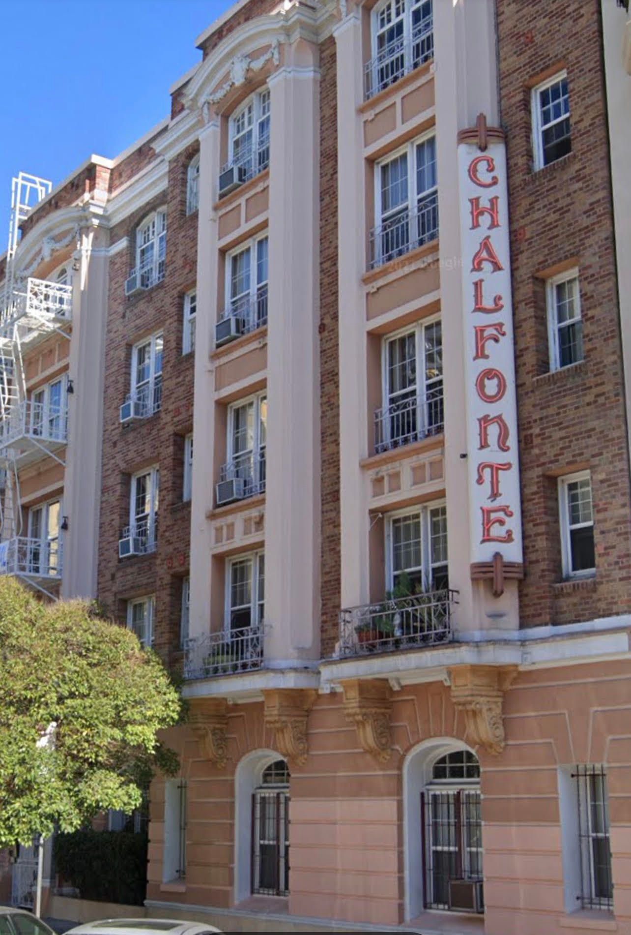 Chalfonte apartment building with cream and brick facade, vertical sign, balconies.