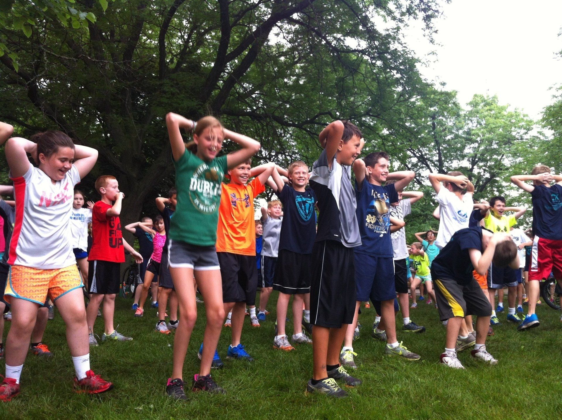 A girl wearing a green shirt that says athletics on it