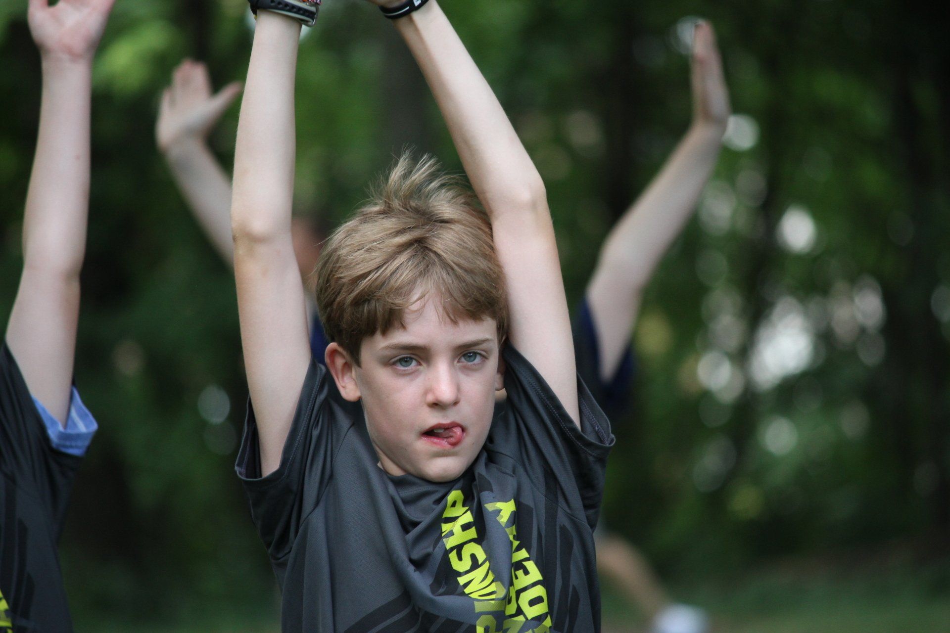 A young boy wearing a black shirt with the word nsw on it