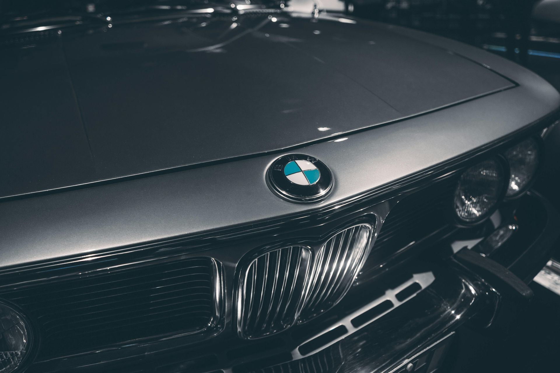 Silver BMW car hood with iconic logo and grill.