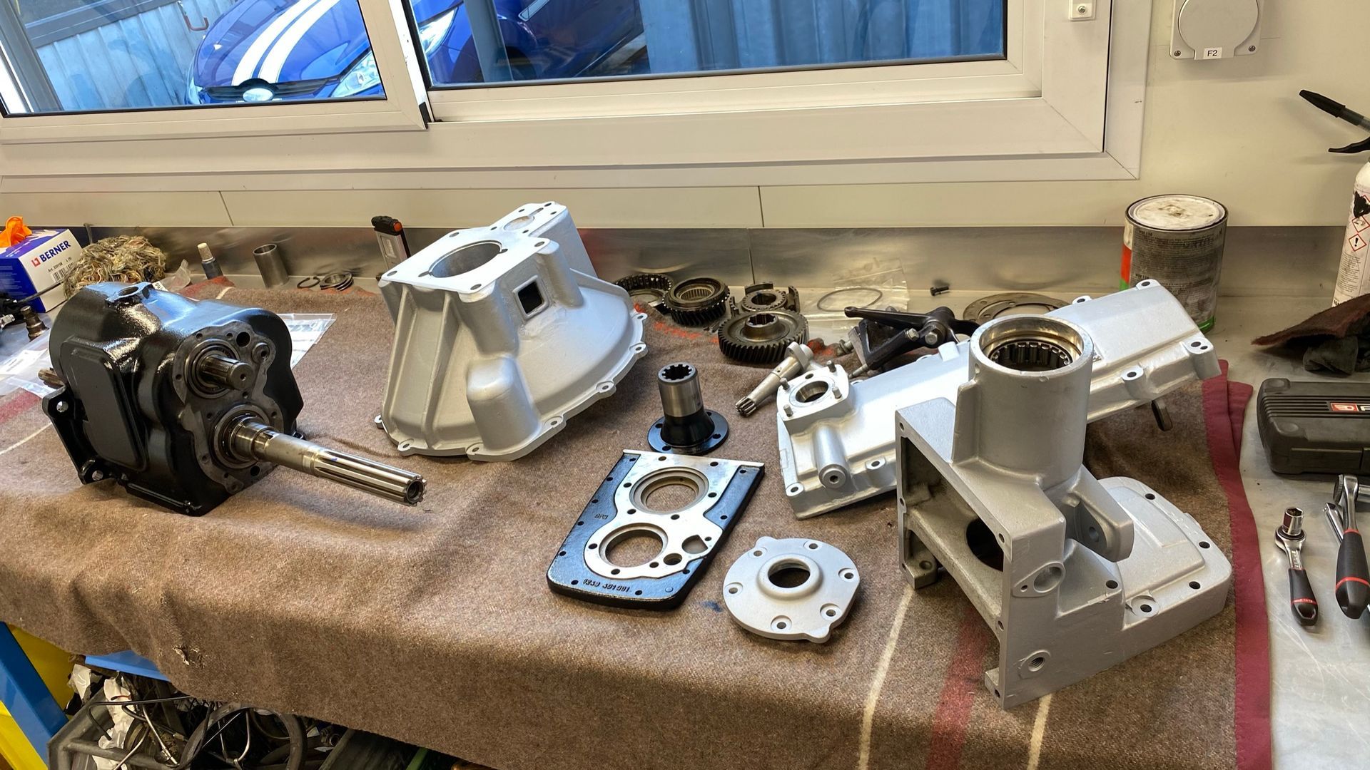 Une table avec de nombreuses pièces dessus et une fenêtre en arrière-plan.