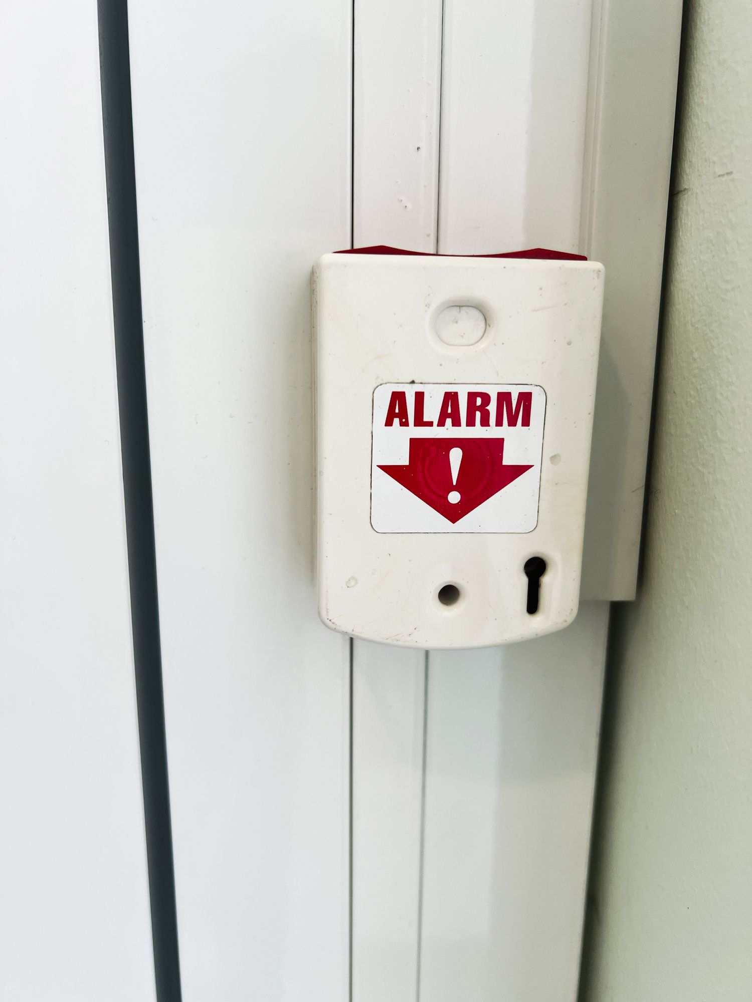 White alarm pull station with red 