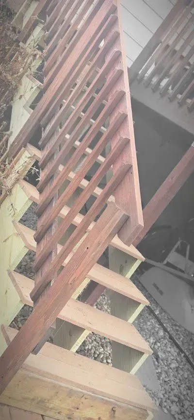 A close up of a wooden staircase with a railing.