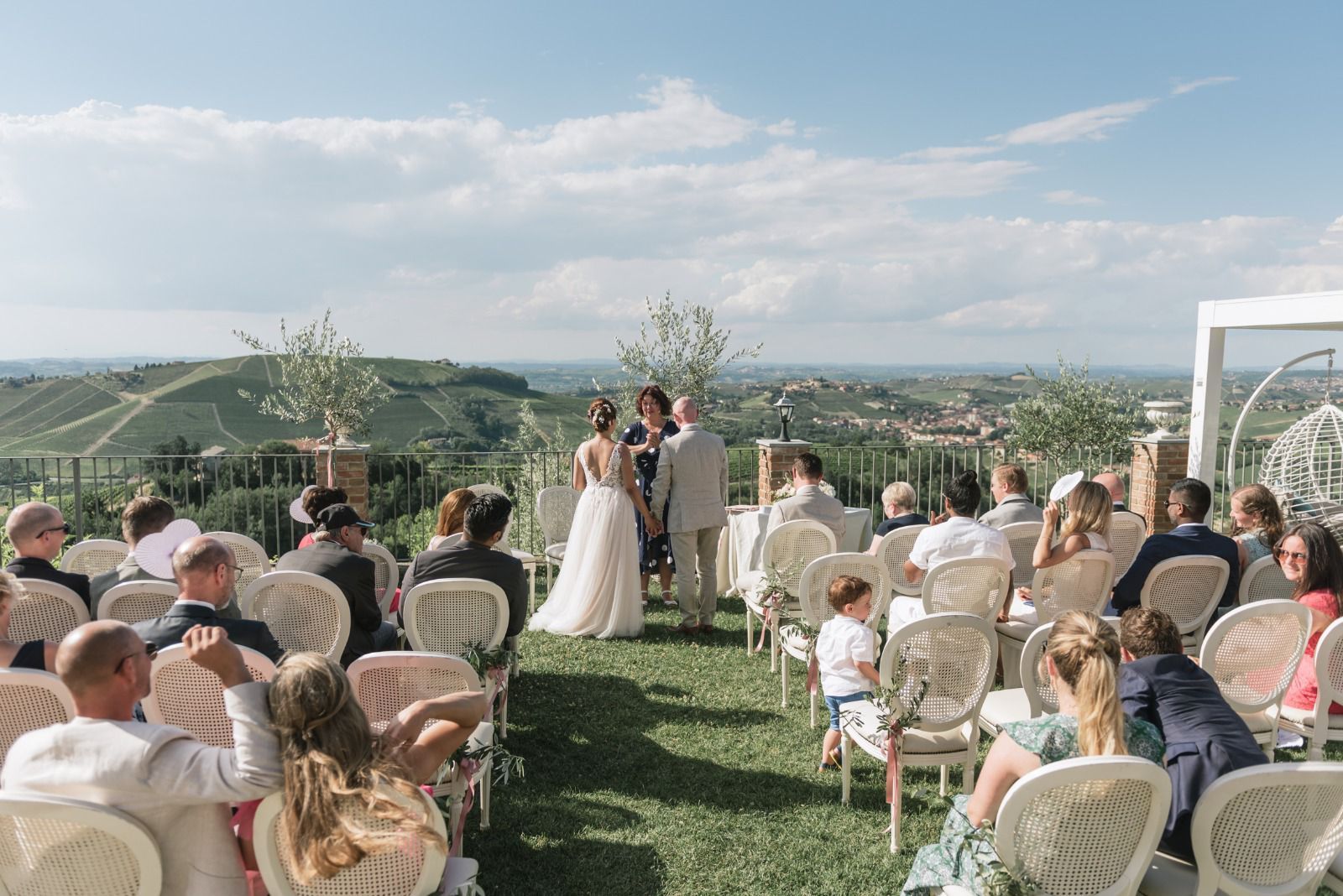 A group of people are sitting in chairs at a wedding ceremony.