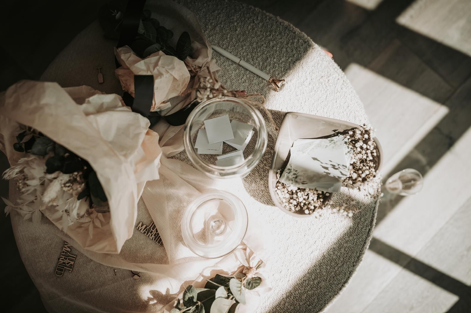 A table with a cake , candles , and flowers on it.