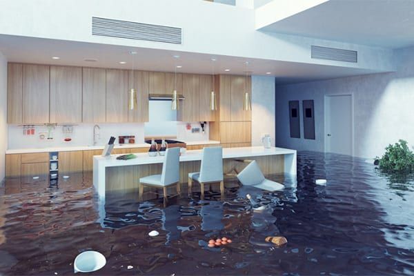 A kitchen and dining room are flooded with water.