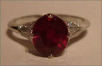Red ruby ring with diamonds in platinum setting
