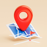 A 3D red map pin icon sitting on top of a blue and white folded paper map against a light beige background.