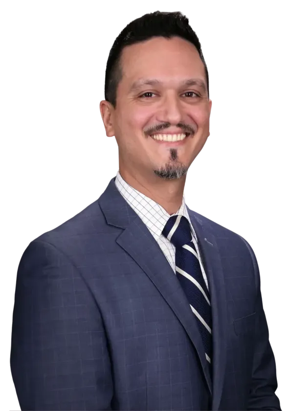 Smiling man in a blue suit and striped tie against a white background